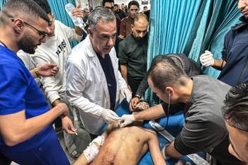 Hossam abu Safieh, director of Kamal Adwan Hospital, oversees the treatment of an injured man in Gaza on November 21, 2024.