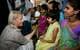 Lise Åserud / NTB Kronprinsesse Mette-Marit holder en liten jente i hånden mens hun snakker med aids- og hiv-smittede pasienter i et sykehus i Mumbai i India i 2006