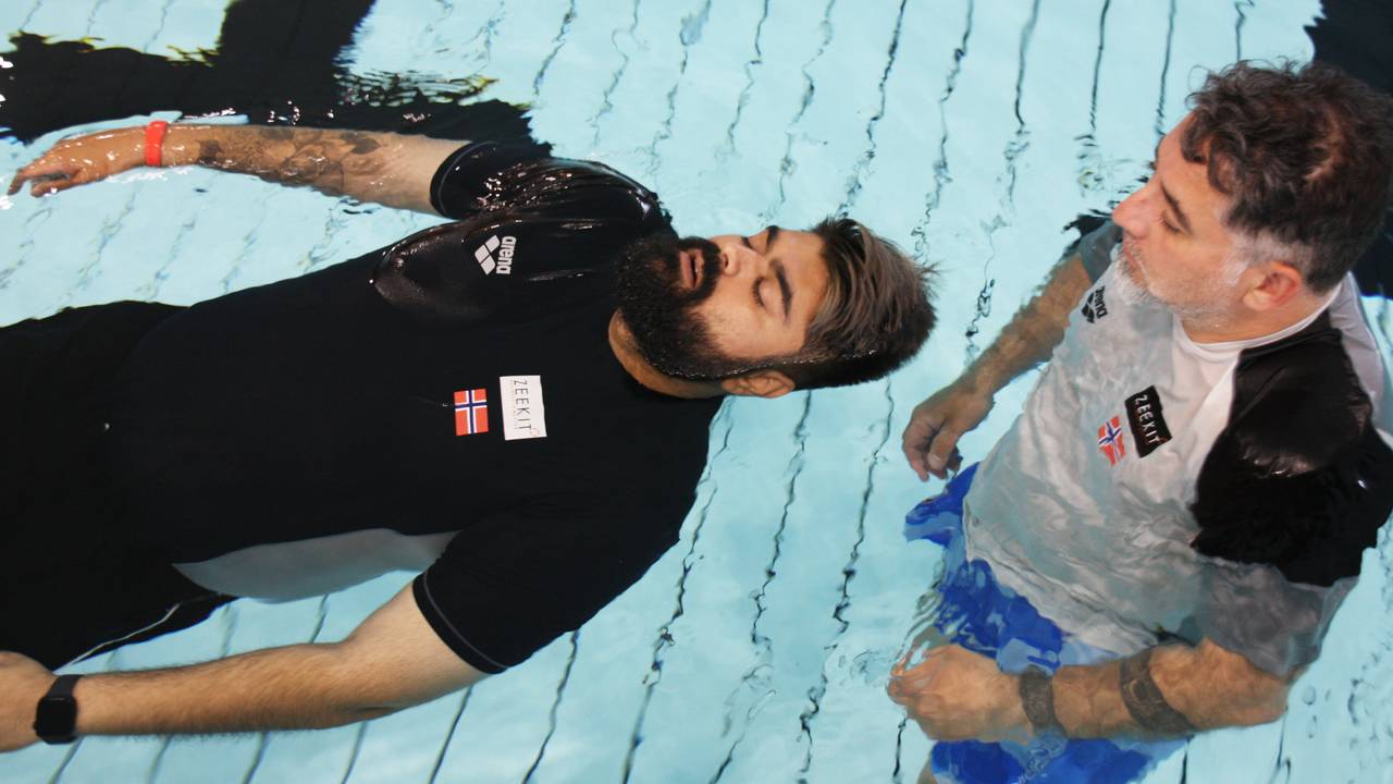 Abubakar Hussain is training to float in the pool. 