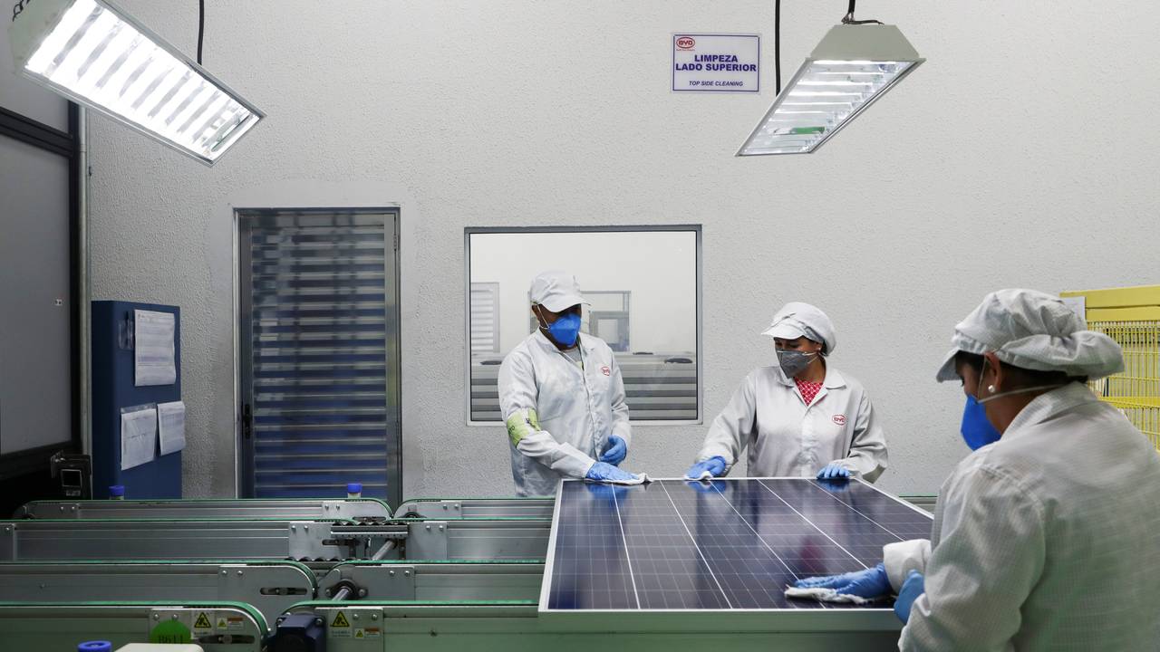 Employees work on a solar energy panel of Chinese solar equipment manufacturer BYD in Campinas