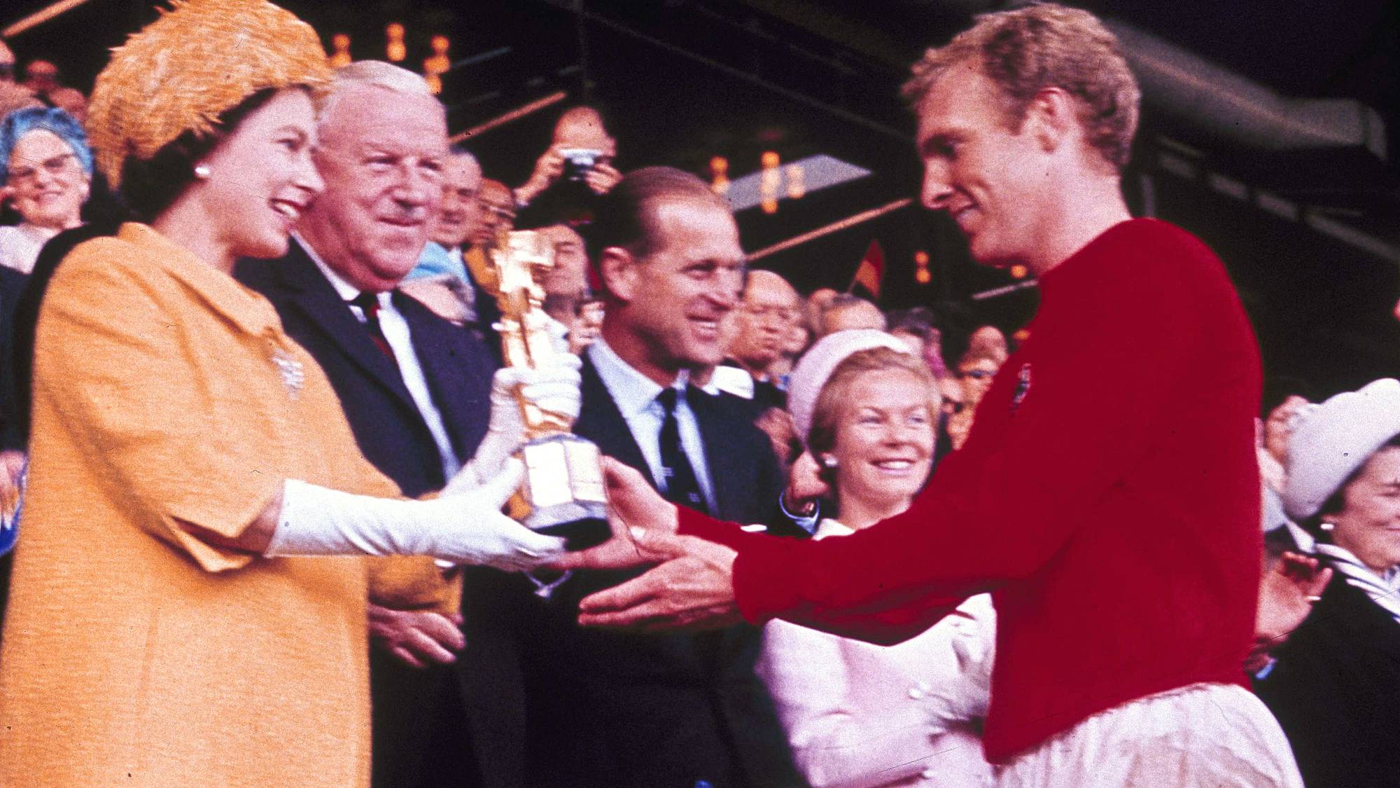 FILE - In this July 30, 1966 file photo Queen Elizabeth II presents the World Cup, the Jules Rimet trophy, to England's team captain Bobby Moore. England beat Germany in the final at London's Wembley Stadium by 4 goals to two, after extra time. (AP Photo/file)