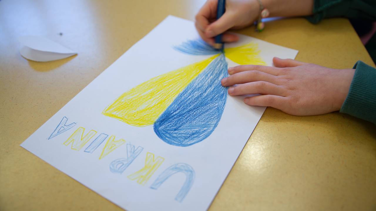 Ella Horn Borgerlin draws with yellow and blue