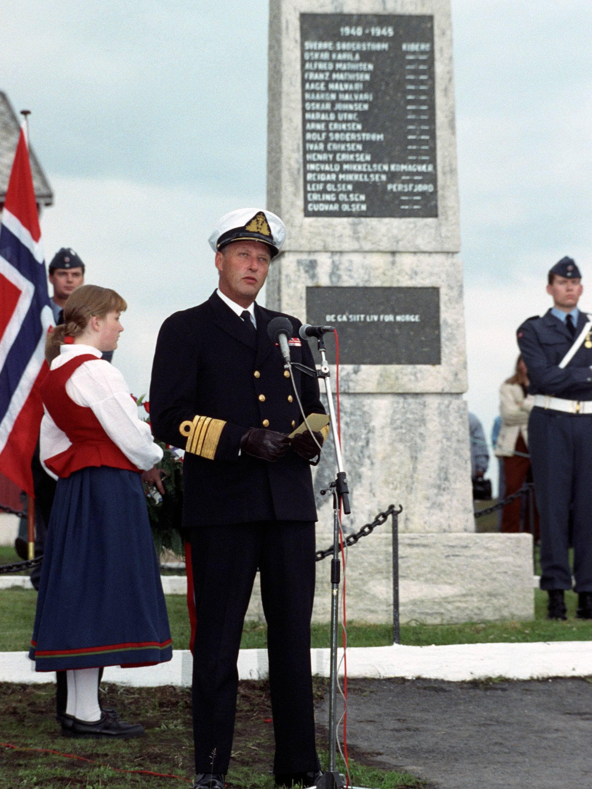 Kong Harald holder en tale foran partisanbautaen i Kiberg i 1992