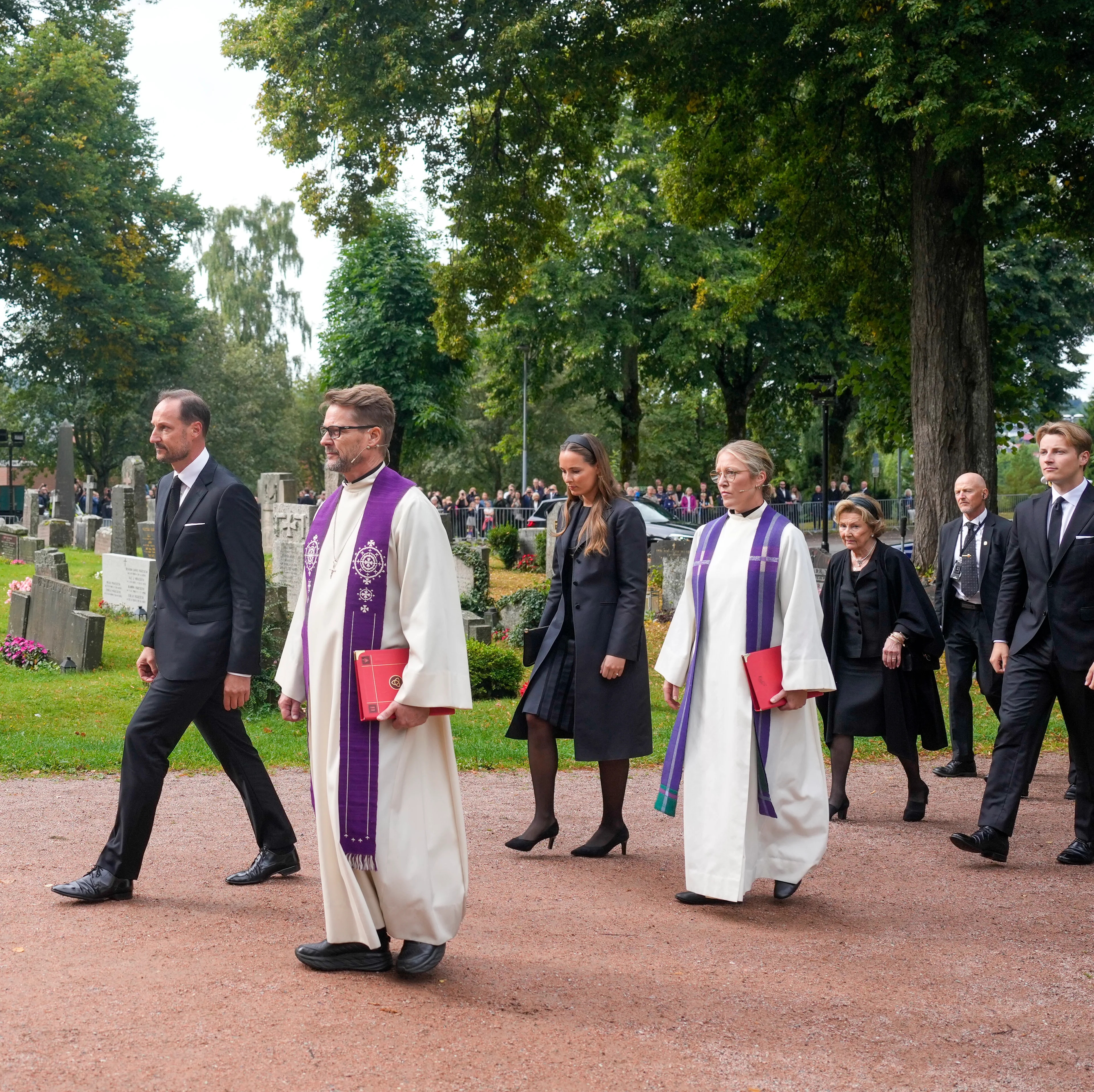 Kronprins Haakon, kongefamilien og prester går inn til Asker kirke.