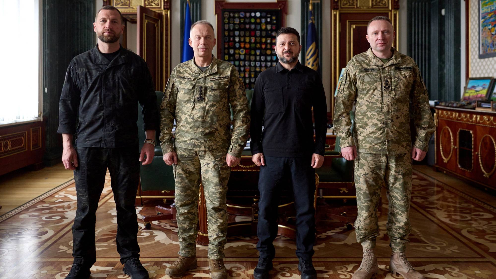 Ukraine's President Volodymyr Zelenskiy, newly appointed Commander-in-Chief of the Ukrainian Armed Forces Major General Mykhailo Drapatyi, his predecessor General Oleksandr Syrskyi, 