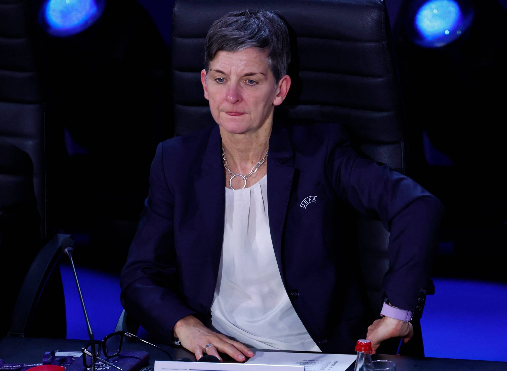  Laura McAllister sitter ved et møtebord i en mørk dressjakke og hvit overdel. (Bildebeskrivelsen er laget av en KI-tjeneste)