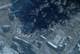 - / 2026 Planet Labs PBC,NTB Et satellittbilde viser røyk fra et industrianlegg.