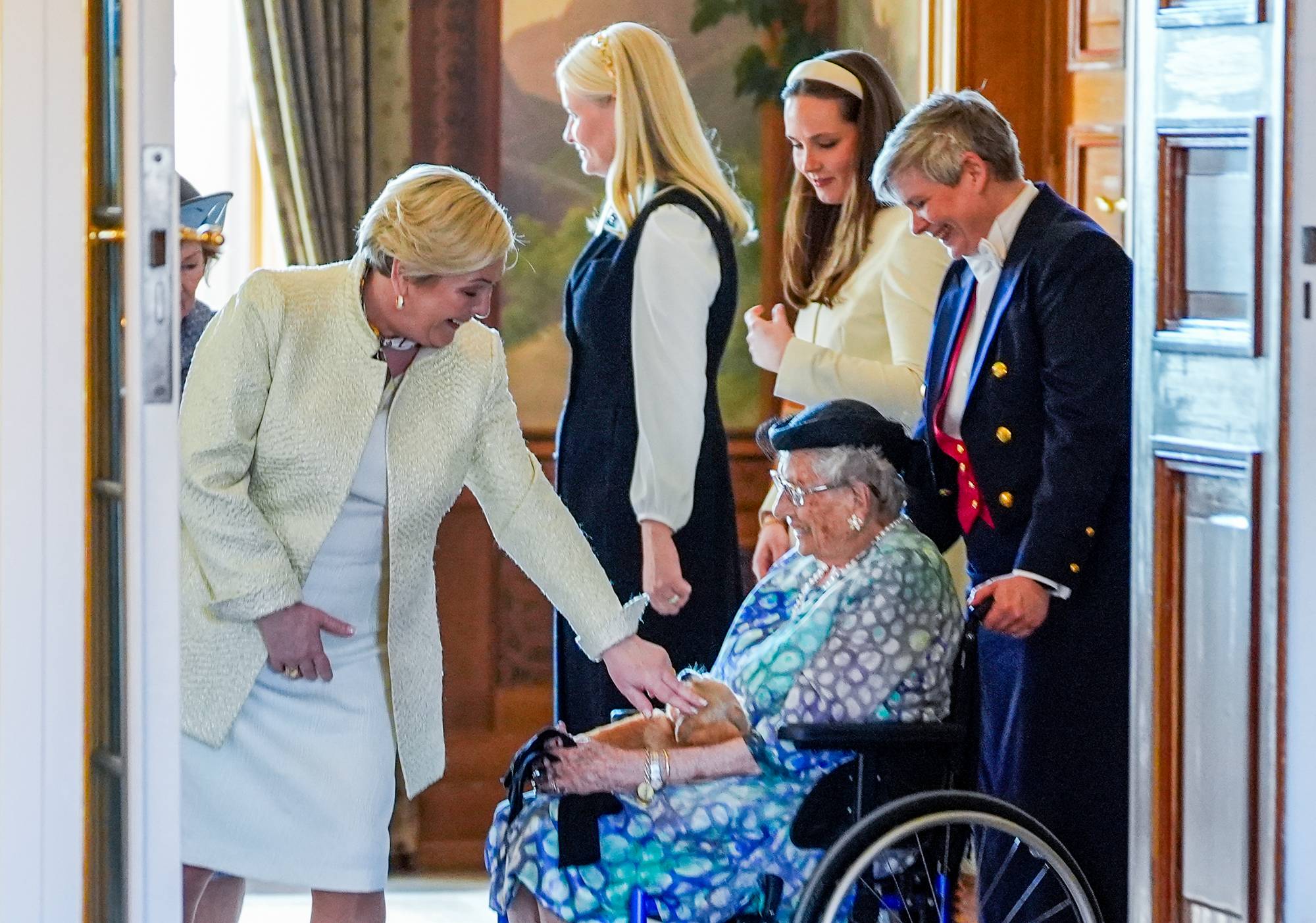 Islands president Halla Tómasdóttir hilser på hunen Wilma, som sitter på prinsesse Astrids fang i Fugleværelset på Slottet