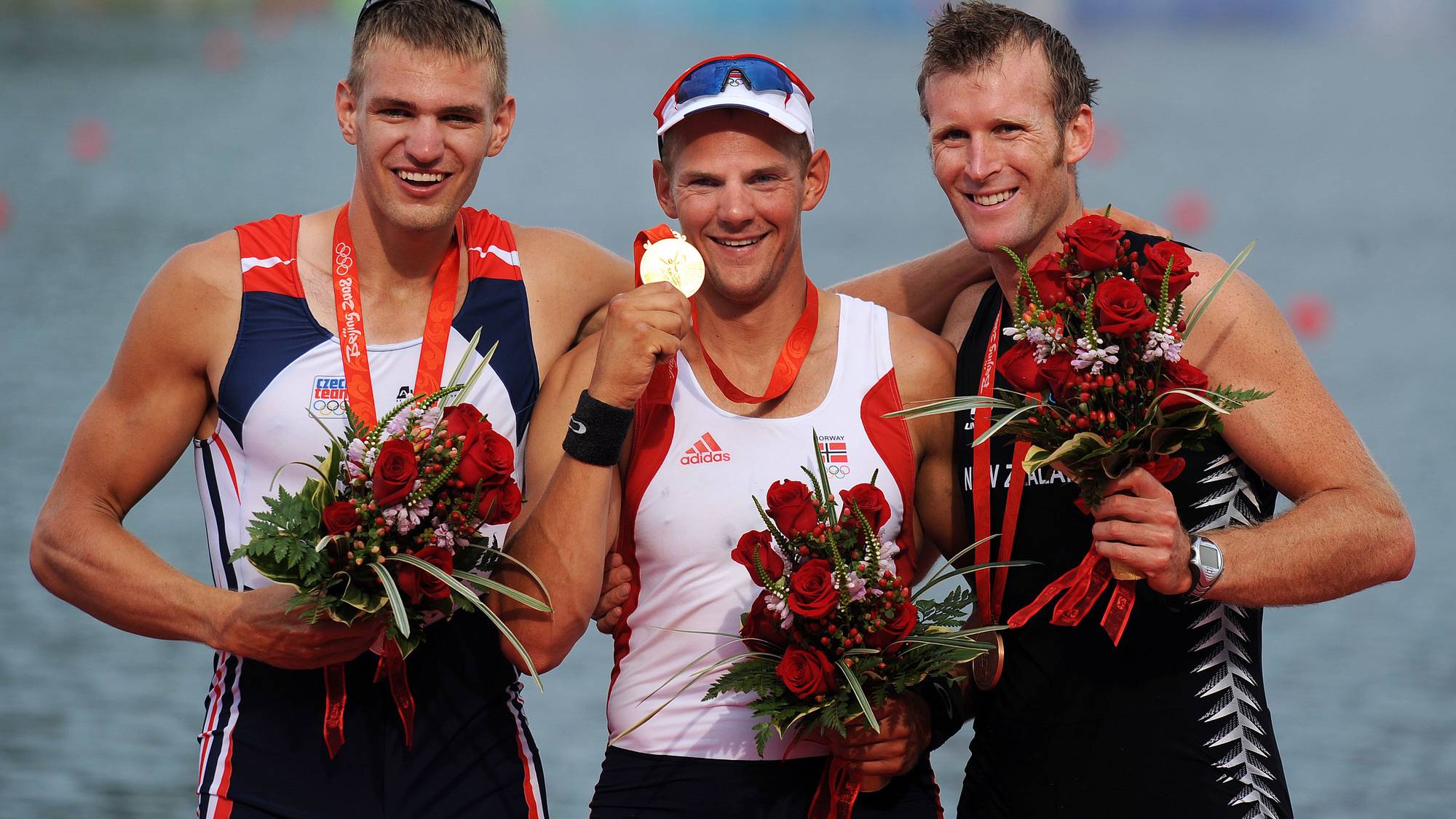 Norway's Olaf Tufte (C) celebrates his win with Czech Republic's Ondrej Synek (L) )and New Zealand's Mahe Drysdale during the medals during the medal ceremony for the men's pair final at the Shunyi Rowing and Canoeing Park during the 2008 Beijing Olympic Games in Beijing on August 16, 2008. Norway won gold, Czech Republic Silver and New Zealand bronze. AFP PHOTO / FRED DUFOUR