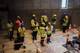 Photo: Truls Skram Lerø / NRK People in yellow vests talk together. Some people look in the direction of the room the ship should end up in.