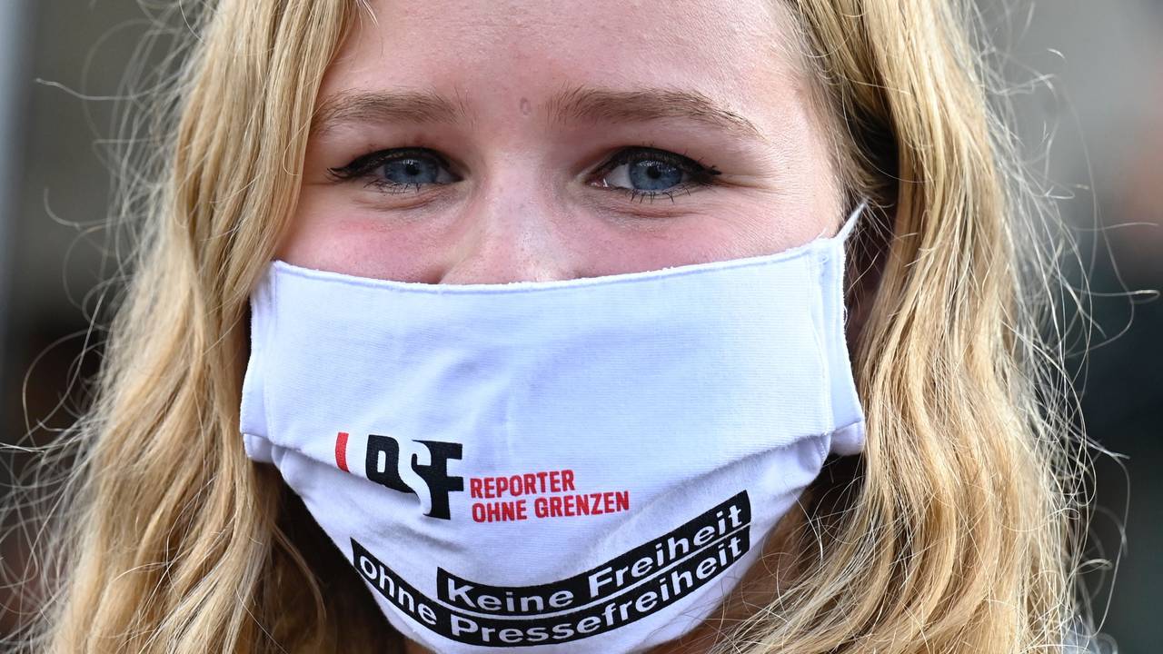 En demonstrant for pressefrihet. På munnbindet står det: