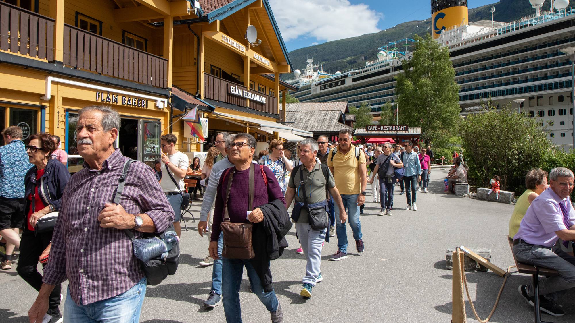 turistar på brygga i Flåm framfor eit cruiseskip