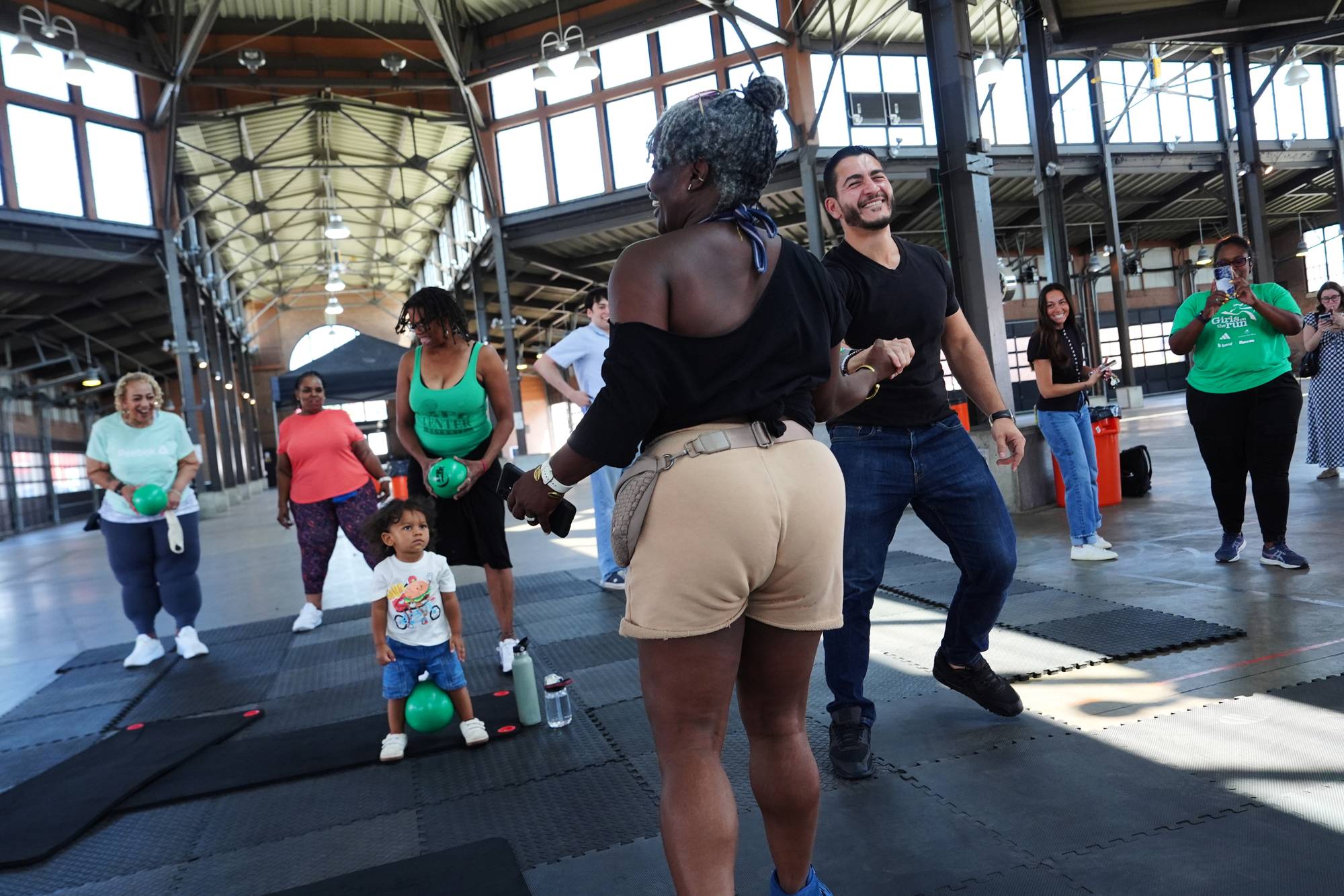 Abdul El-Sayed, a progressive candidate in the Democratic primary for U.S. Senate in Michigan, takes part in a fitness class as he visits Eastern Market on election day.
