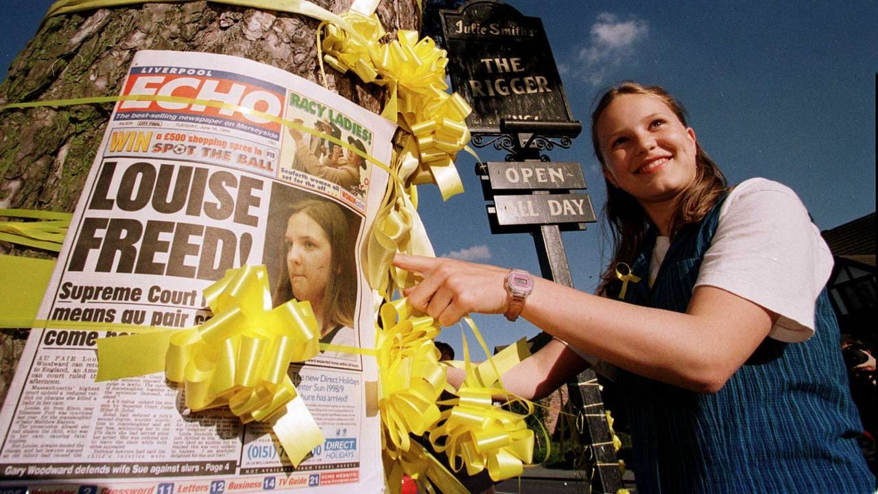 Hayley Nixon, 13, ties a yellow ribbon around a tree outside the Rigger pub in Elton, Cheshire, after villagers heard of the release of British nanny Louise Woodward