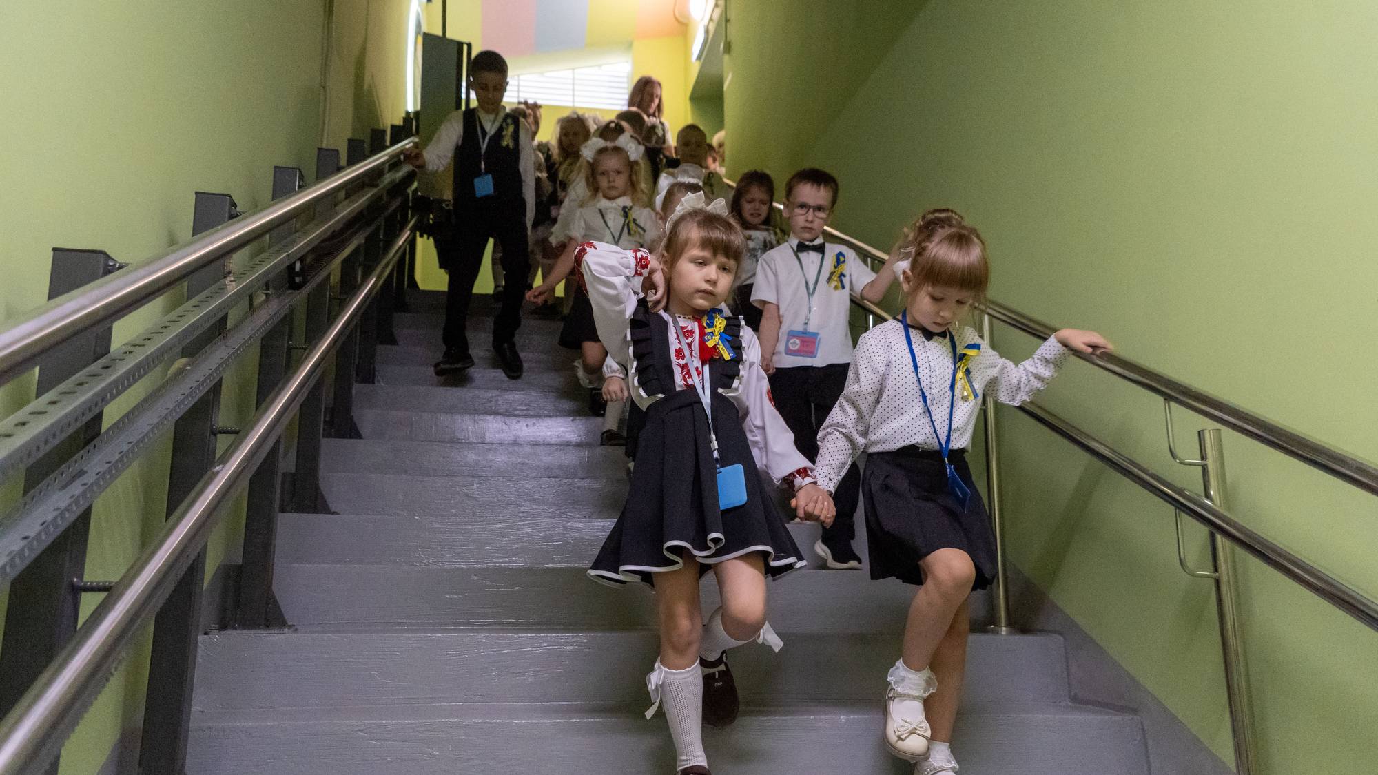 School children enter an underground school on their first day back, in Kharkiv, Ukraine, Tuesday,
