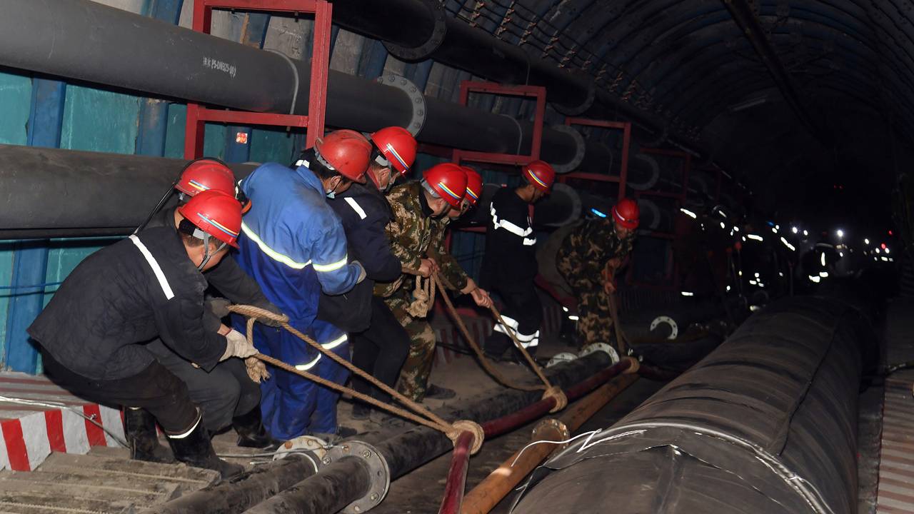 Rescuers work at the site where a coal mine flooded in Hutubi county, Xinjiang