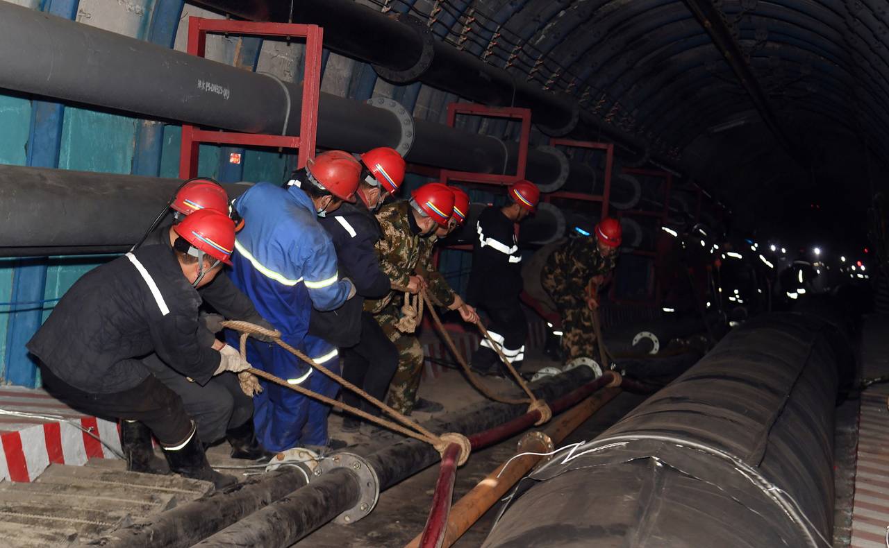 Rescuers work at the site where a coal mine flooded in Hutubi county, Xinjiang